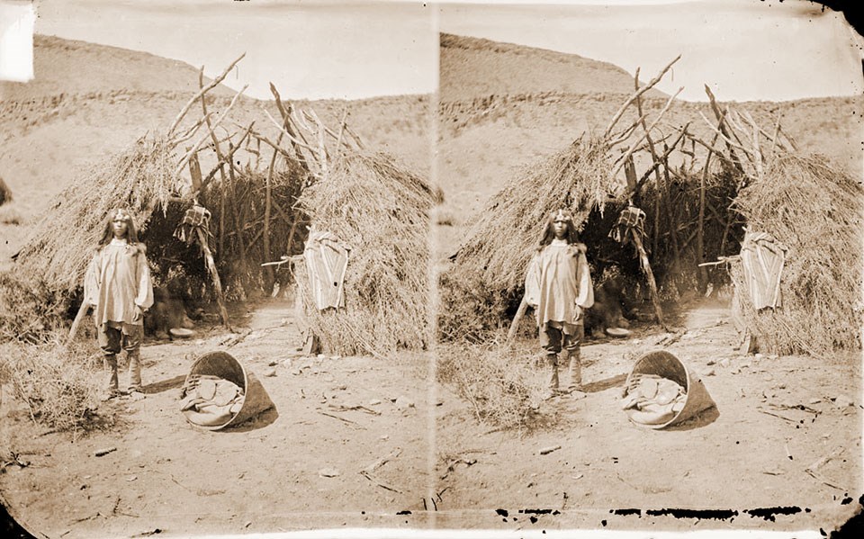 Southern Paiute boy by wikiup shelter