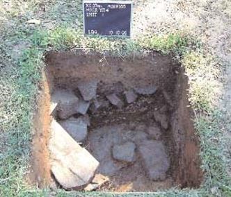 A small square pit with stones inside and a stone foundation. This is the site of a Cellar hole found in the Whitby Cellar.