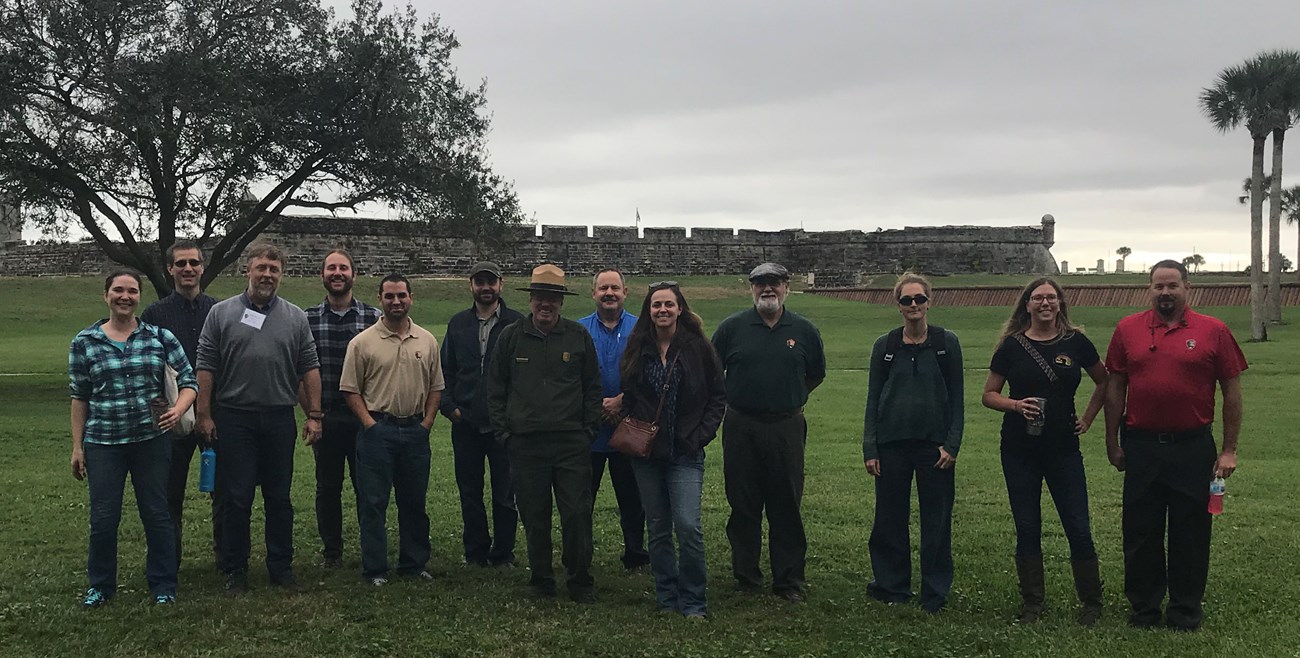 Meeting attendees tour Castillo De San Marcos National Monument. Group standing in front of fort