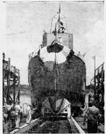 The U.S.S. Implicit minesweeper sliding down the ways into the Savannah River A grainy black and white photo of a minesweeper on tracks