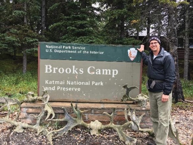 Scott Babcock standing in front of Brooks Camp sign