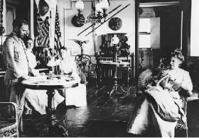 Frederick and Eda Funston entertaining friends in their parlor.  Eda is seated on the far right. Kansas State Historical Society