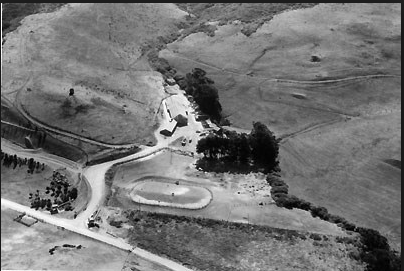 Ranch B Dairy Farm Building Birds eyes view of farm clustered in vally