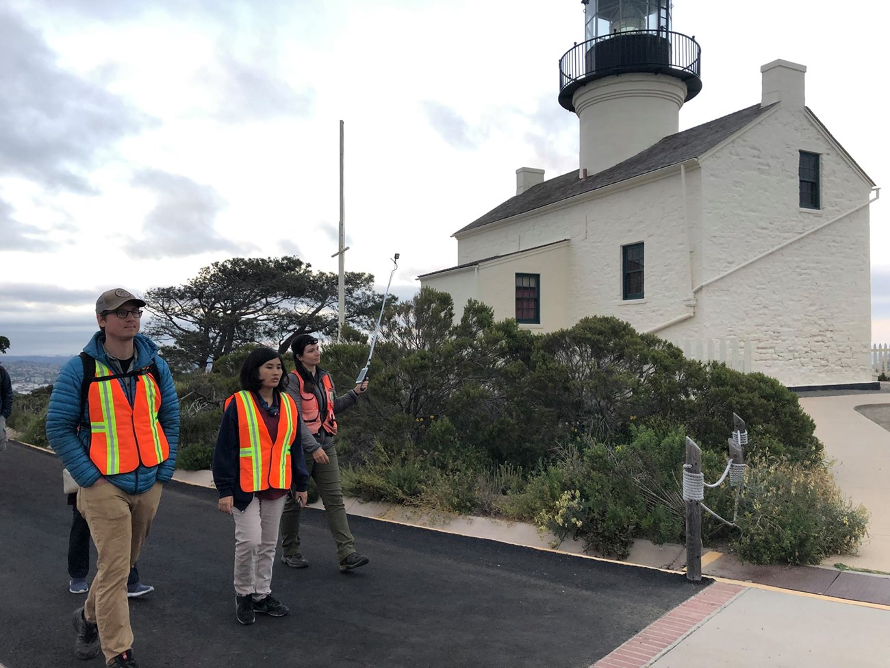 Park Ranger Stephanie Root holds a device called an Echometer Touch as she guides biologists and volunteers on a walk around the park, searching for bats.