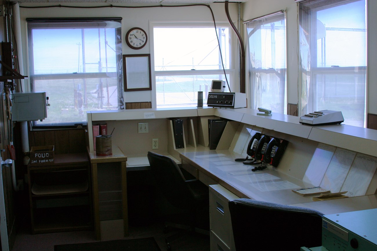 Security Control Center Office with a large console desk and many windows