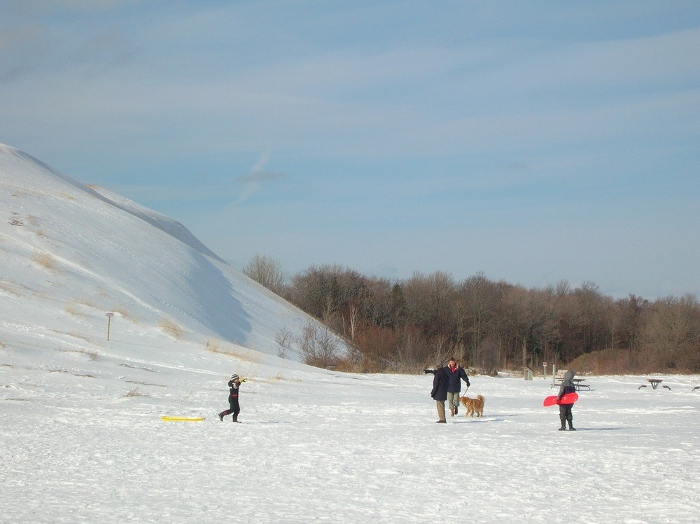 family and dog sled in snow