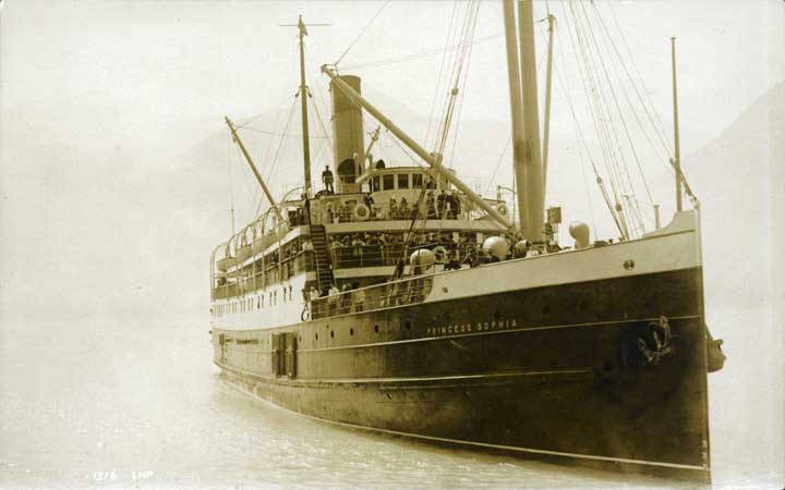 Historical image of ship in water with passengers on deck.