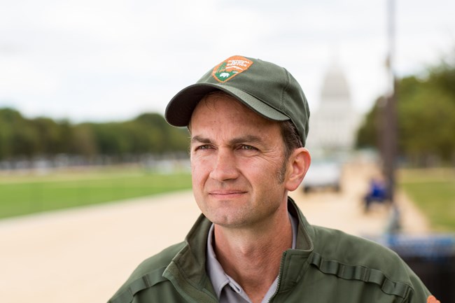 a headshot of michael with uniform ballcap