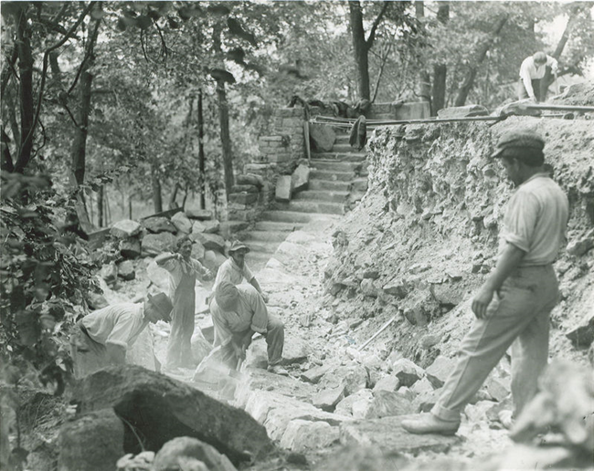 Stan Hywet Hall in the 1920s B&W photo of construction workers building a wall.