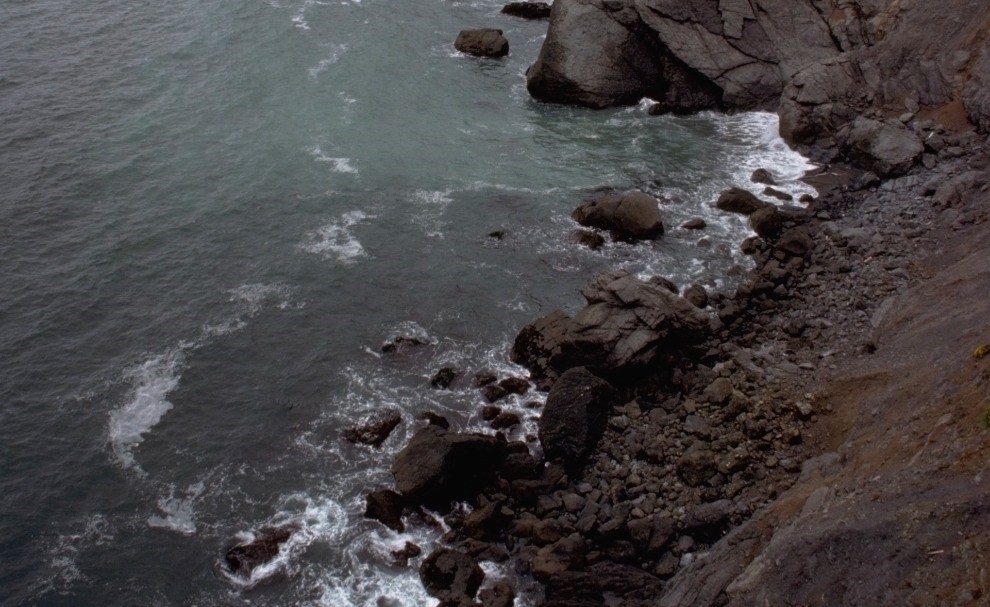 Storms_Response_Grain03 view looking down cliff to narrow rocky beach