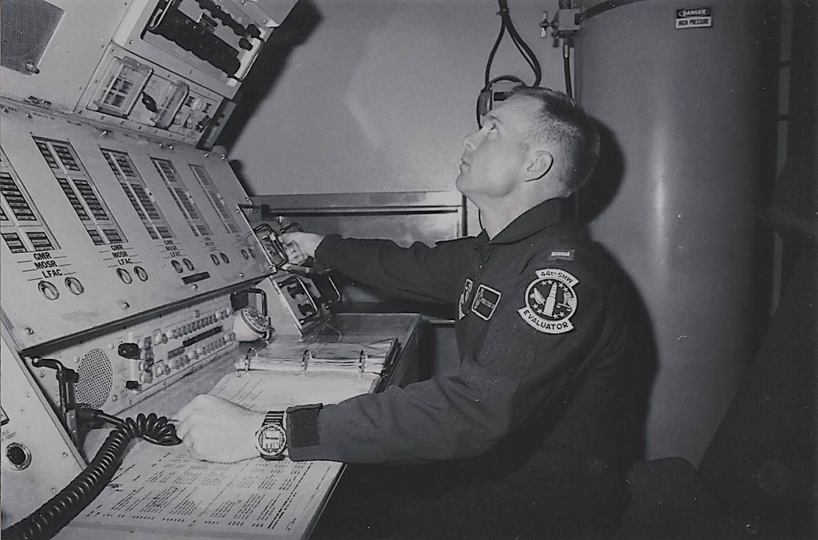 Officer at a control center trainer An officer seated in front of a tall electronic control panel.