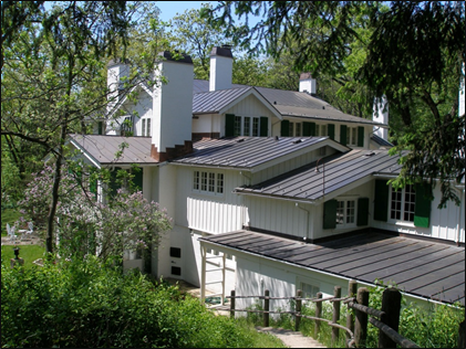 Large white house with green shutters.