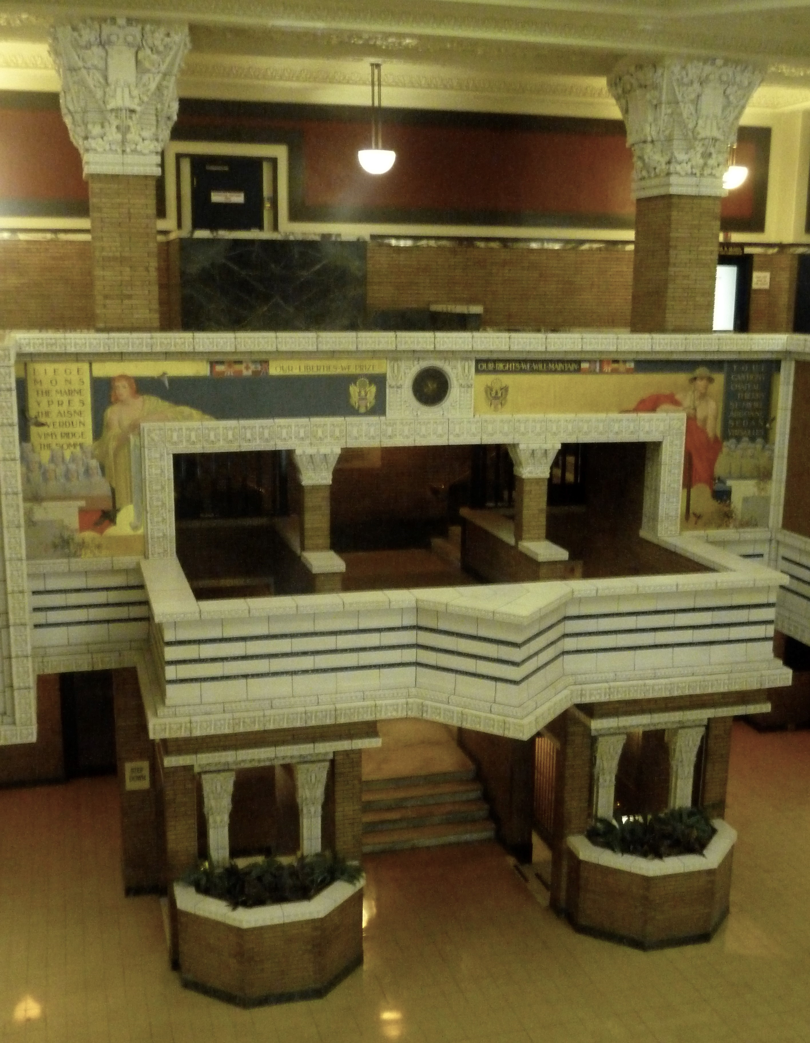 Terra Cotta Frames Mural White mezzanine with colorful murals on the wall.