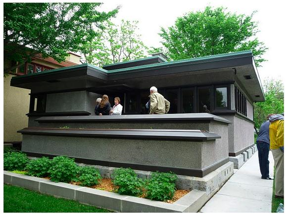 The Arthur L. Richards Small House Grey house with people on the front porch.