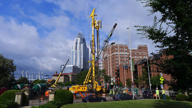 The Lytle Tunnel Rehabilitation Project. Tall buildings and construction machinery.