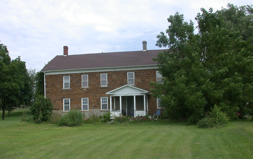 The Stonehaus Stone house among trees.
