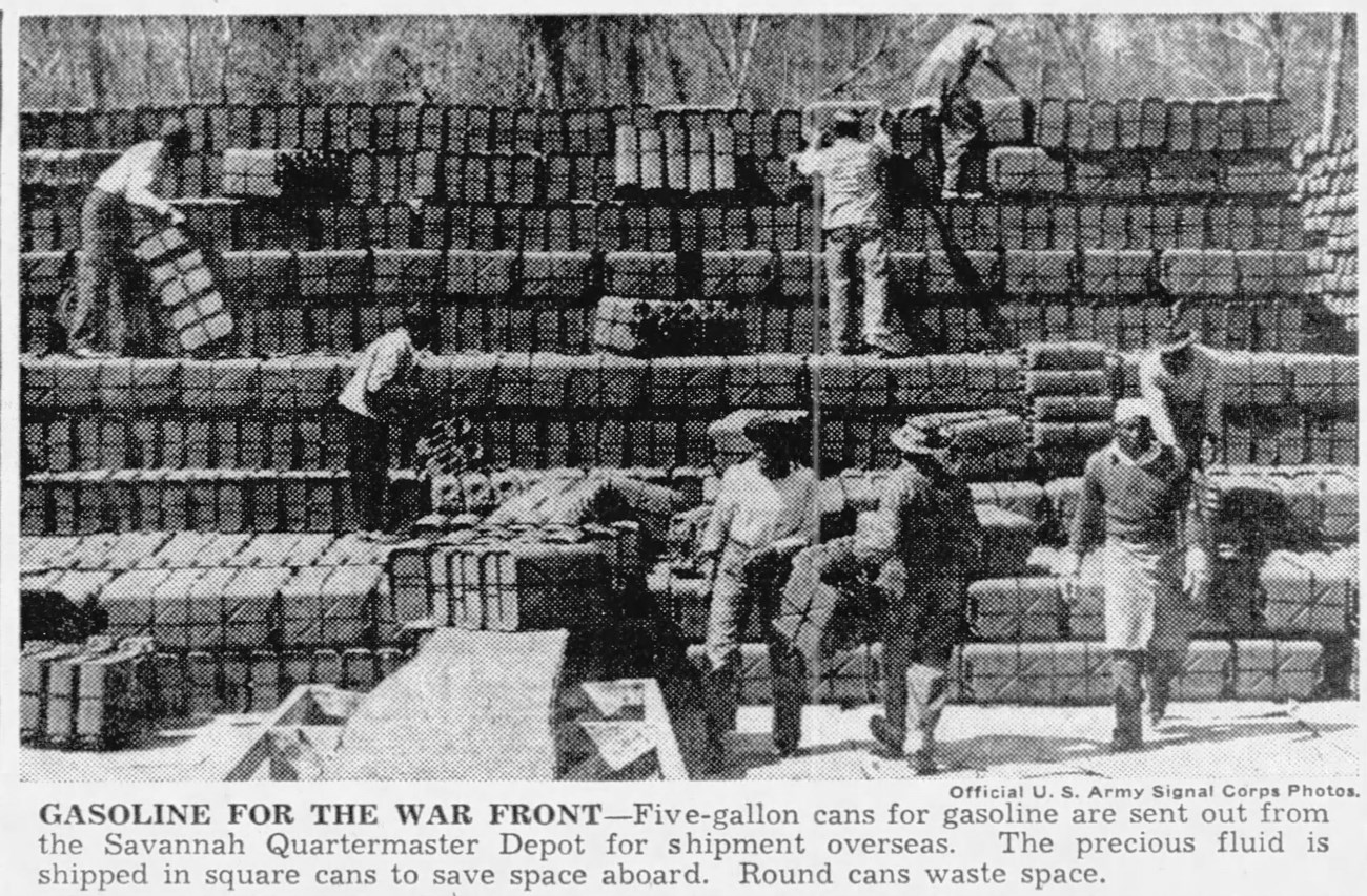 Gasoline for the War Front Black and white photograph of African American men moving gasoline cans