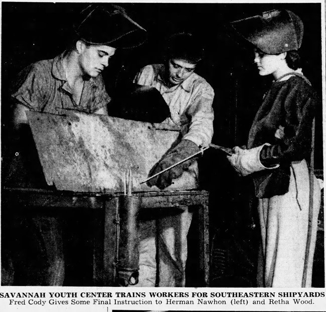 Savannah Youth Center Trains Workers for Southeastern Shipyards Black and white photo of two youths wearing welding masks being trained on metal work by an adult male