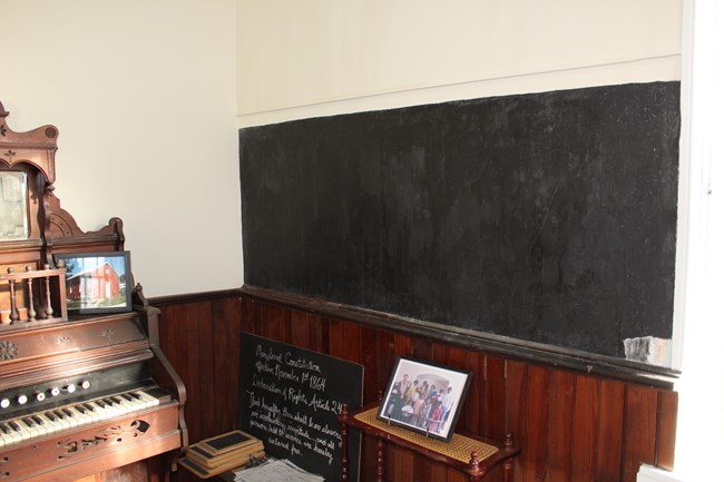 A church wall painted with dark liquid slate to create a chalk board.