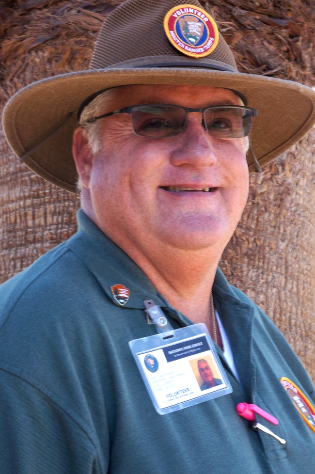 Photo of a volunteer smiling at the camera.