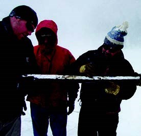 Three UNC researchers examine an extracted core from Bear Lake.