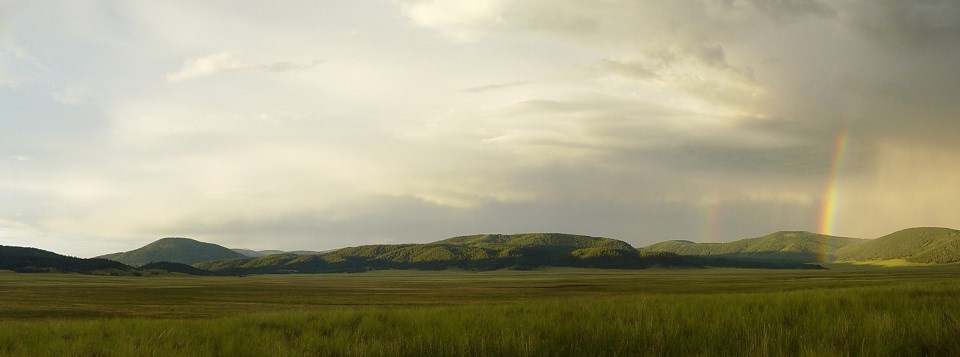 Rainbow over a mountain range and valley