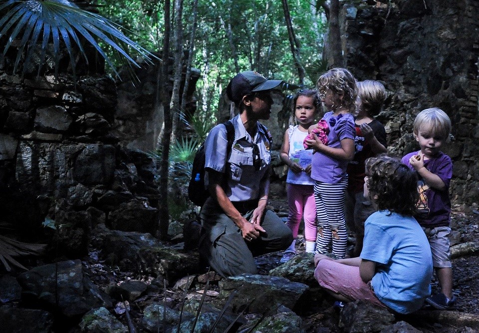 Ranger with a group of kids in a tropical forest