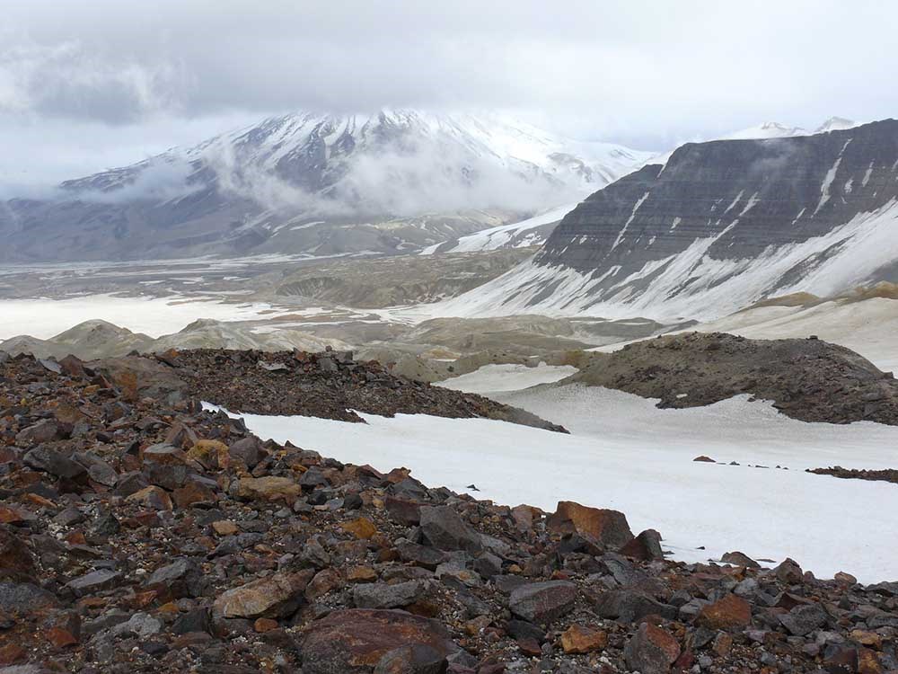 A volcanic valley with snow.