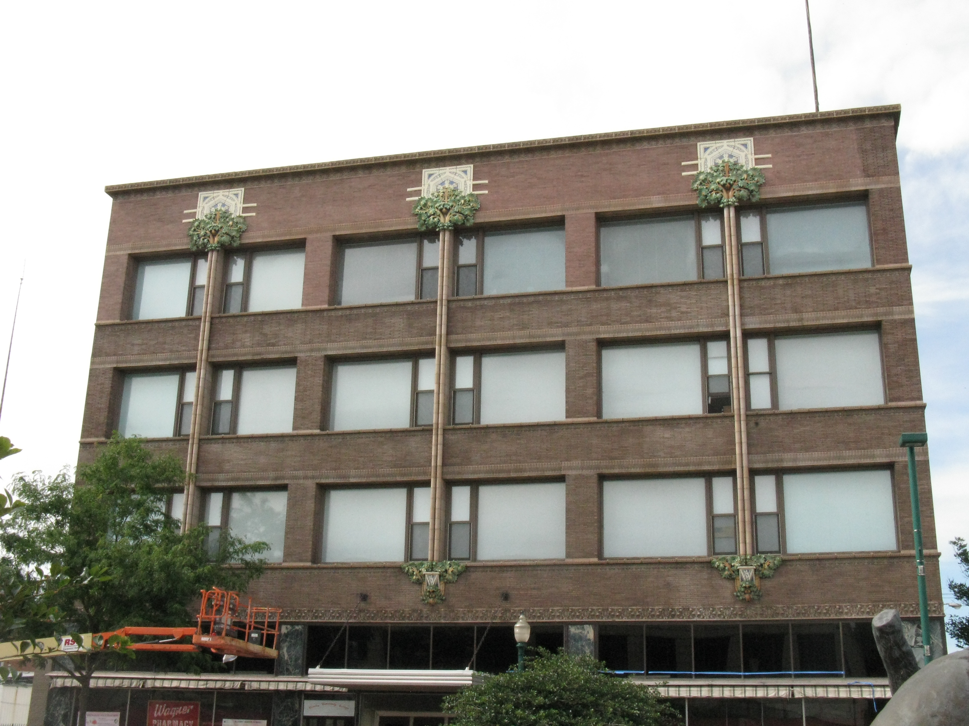 Brick building with large windows and a lot of architectural detail.