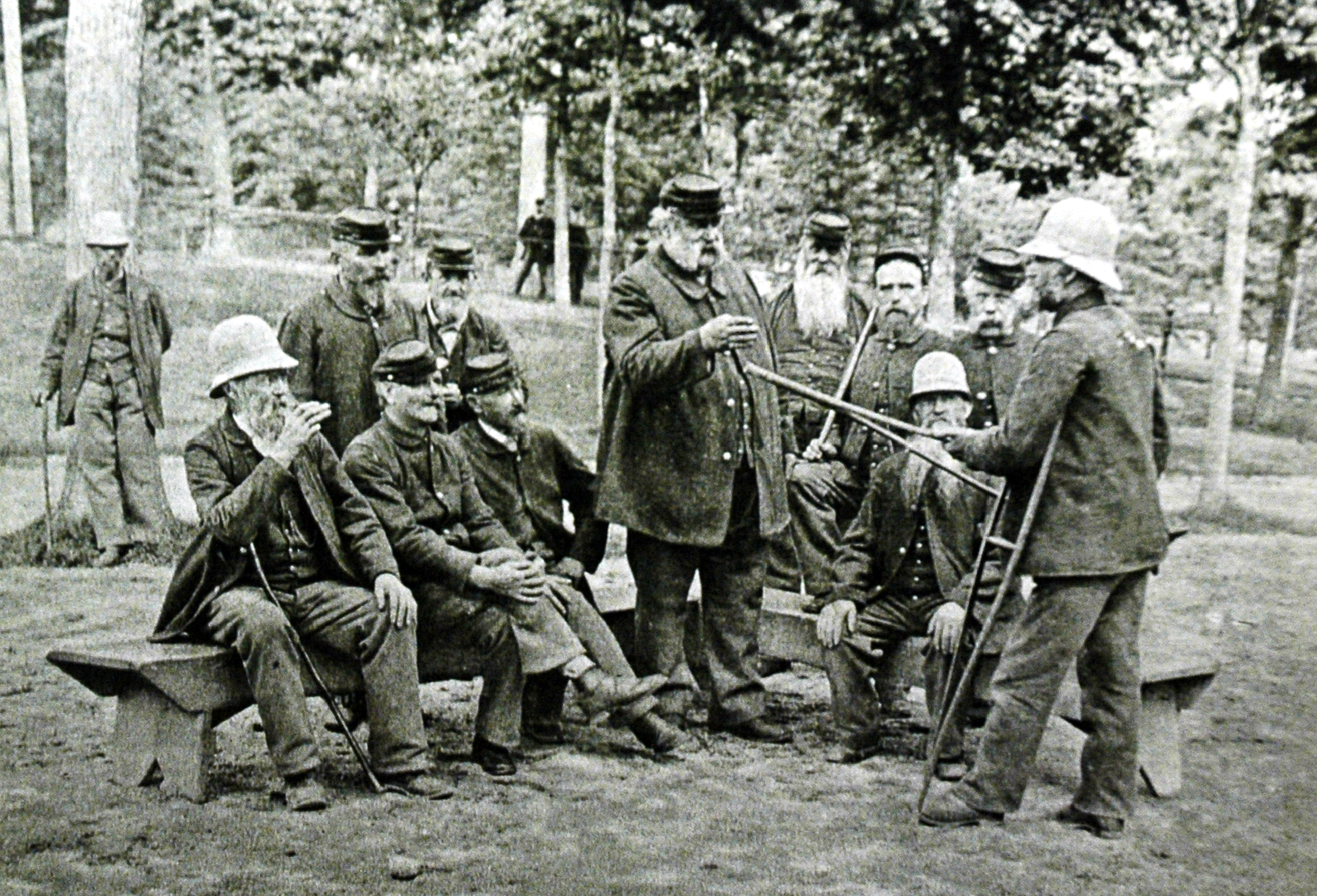 Veterans at a NHDVA facility B&W photo of men standing and sitting in a group.