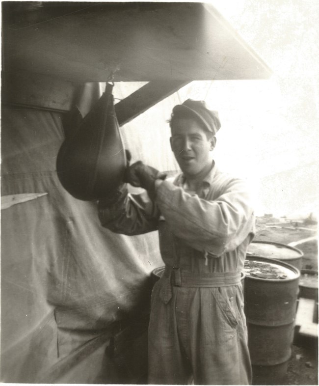 Vincent Bell on one of the Aleutian Islands Black and white photo of young man punching a small punching bag.