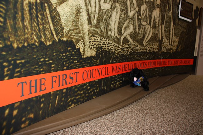 Pup in front of first council sign