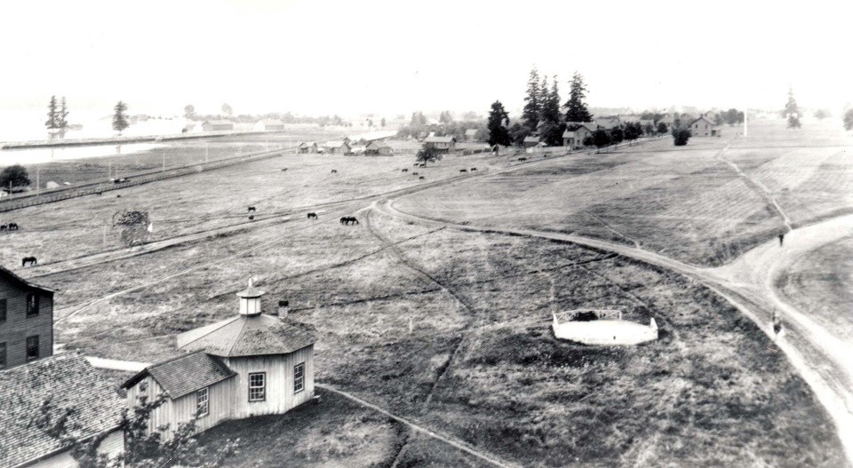 Vancouver Arsenal - Vancouver Arsenal Guardhouse during high water, 1880s, National Archives and Records Administration Black and white photo of Vancouver Barracks with open fields and some buildings.