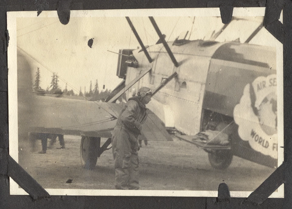 DWC serviced at Vancouver Barracks Photo of man in flight suit standing next to a biplane aircraft