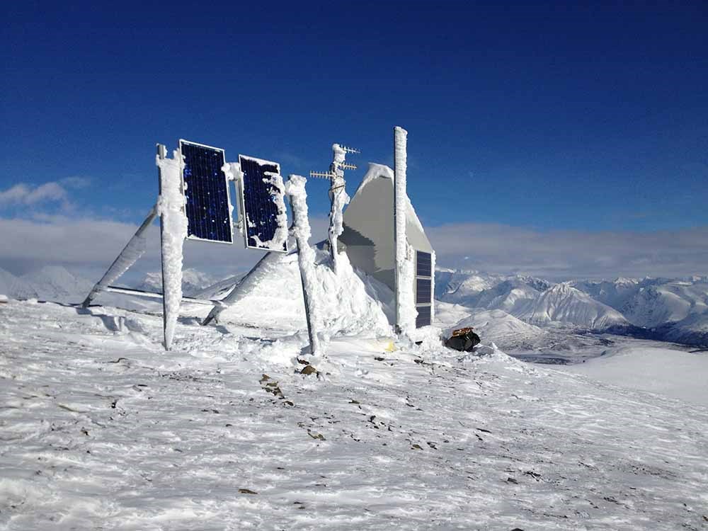 A snow-covered instrument station high in the mountains.