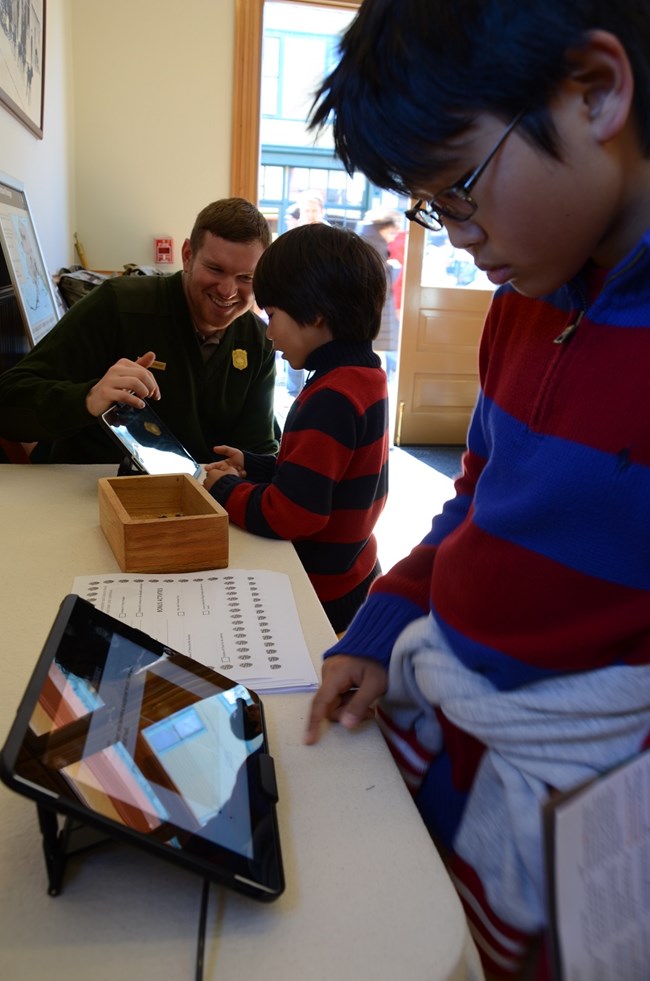 Ranger and two children using tablets