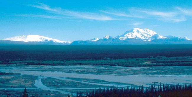 wide river with snow covered mountains in the distance