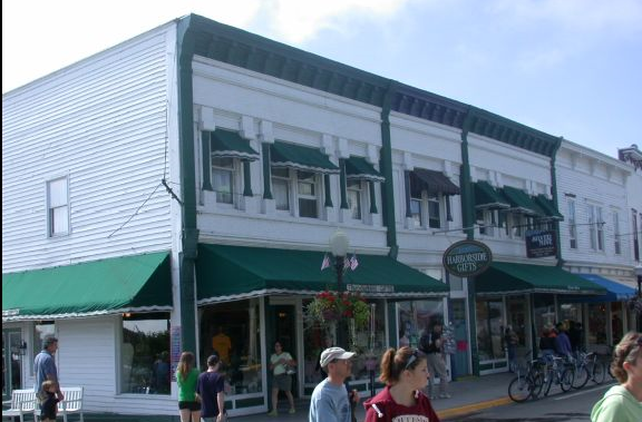 White building with green awnings.