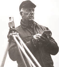 William Field Glaciologist William O. Field holds pencil and notepad next to surveying tripod. Black and white image.