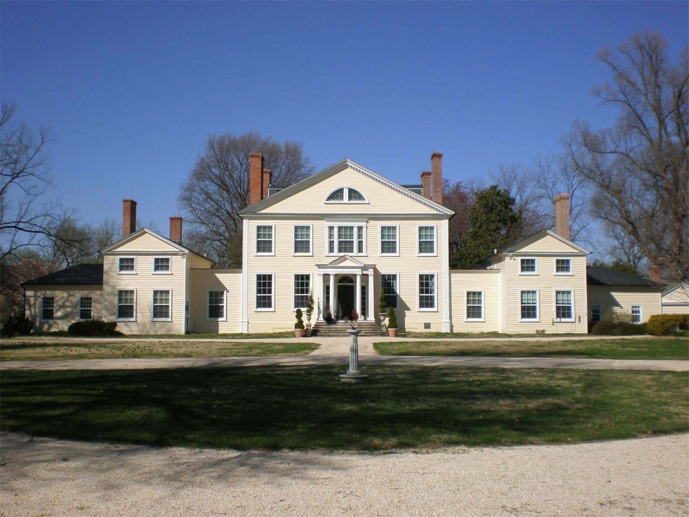 White estate house viewed from driveway