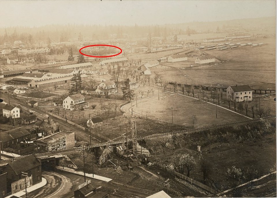 YMCA nara with circle Black and white aerial photo of Vancouver Barracks with one building in the center of the image circled in red.