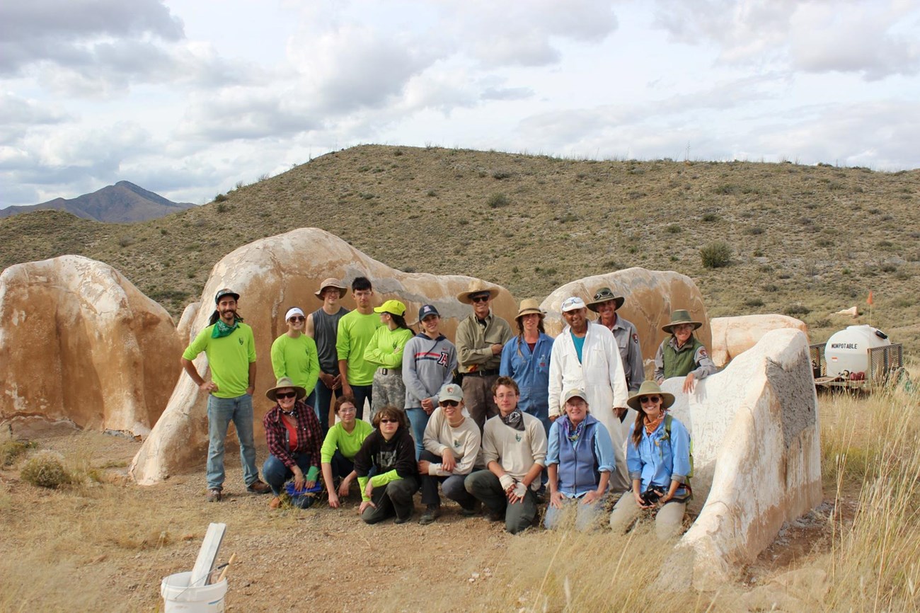 Field school participants, including students from the youth summit, pose for a photo in front of the ruins of the Post Trader's store. Field school participants, including students from the youth summit, pose for a photo in front of the ruins of the old Post Trader's store at Fort Bowie NHS.