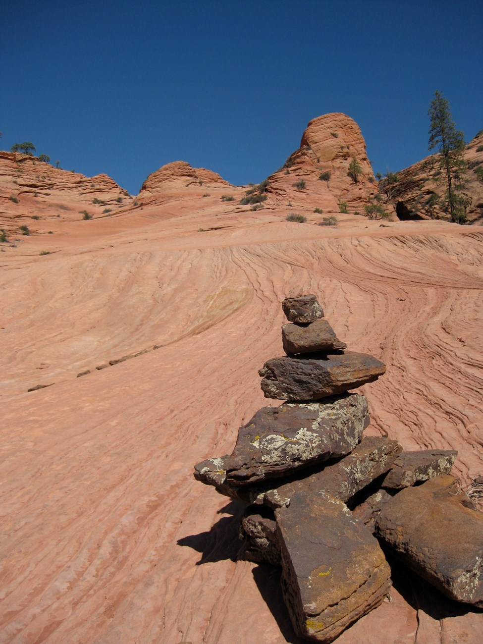 small conical rock pile on the dirt trail