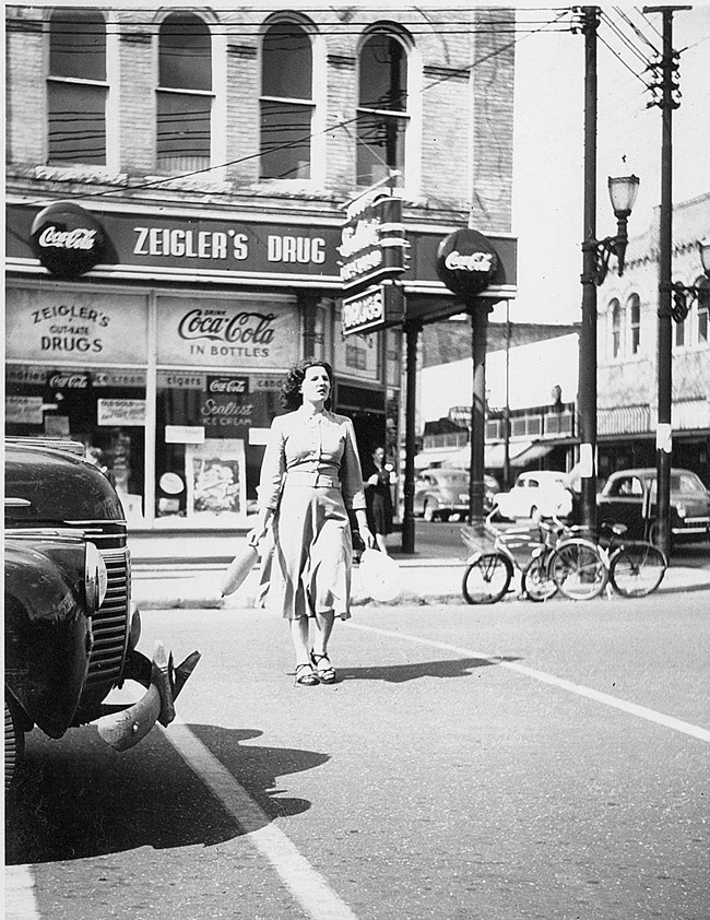 Woman walking by Historic Zeigler's Drug Store