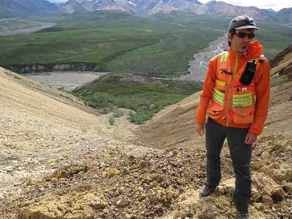 A scientist stands by a major landslide.