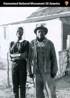 Two Homesteaders outside their home
