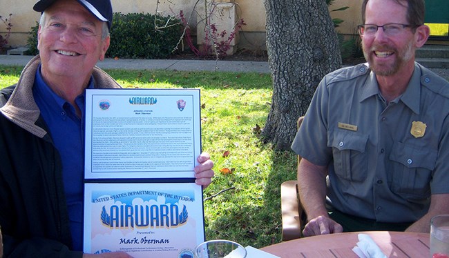 Mark Oberman (left) holds Airward, while Channel Islands ranger, Ian Williams sits to the right.