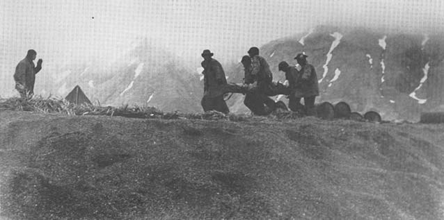 soldiers carrying a litter on a hill