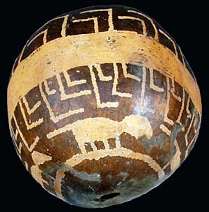 Gourd with designs etched into its surface.