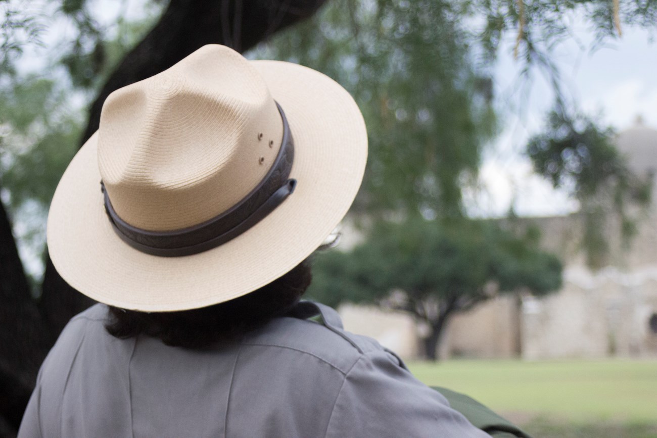 Ranger Hat Ranger wearing hat looks to Spanish mission